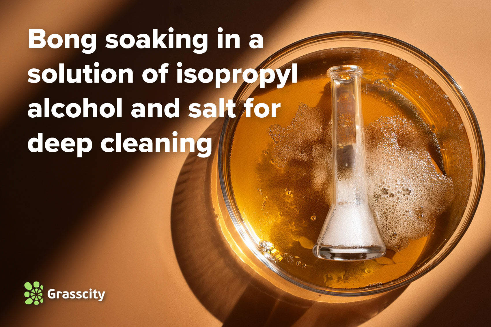 Bong soaking in a solution of isopropyl alcohol and salt for deep cleaning