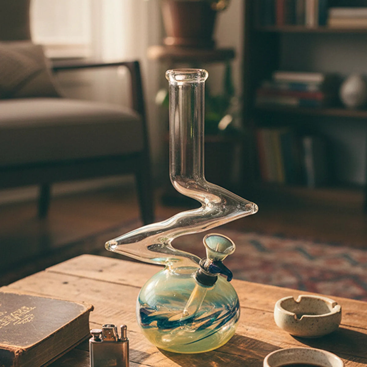 Front view of the LA Pipes 10" Zong Bubble Base Bong showing its clear zigzag neck rising from a green swirled bubble base on a wooden table.