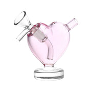 A close-up, angled view of the 3" From The Heart Glass Mini Bubbler, showcasing its clear glass construction and compact size.