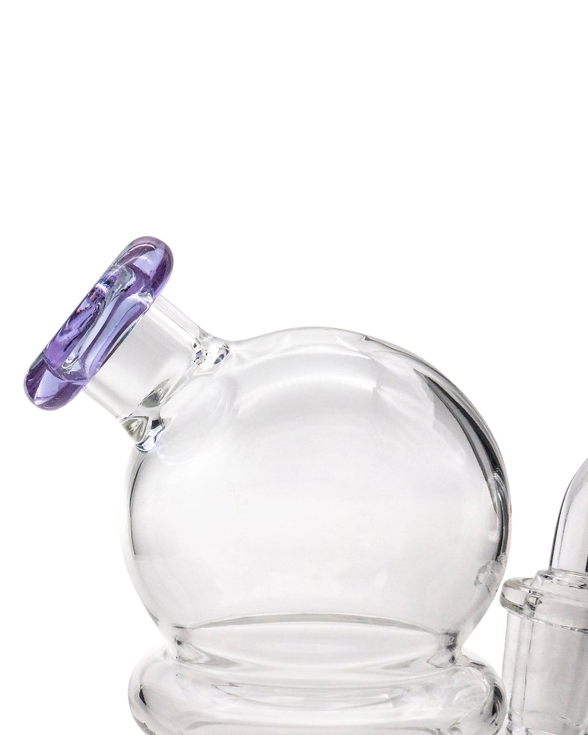 A close-up, angled view of the Nano Globe Rig, showcasing its clear glass construction and rounded shape.